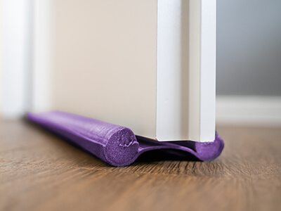 A draught excluder under a door