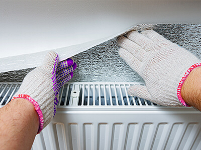Foil insulation behind a radiator