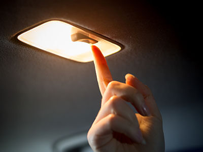 hand turning off car light