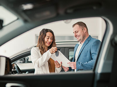 2 people in a car dealership